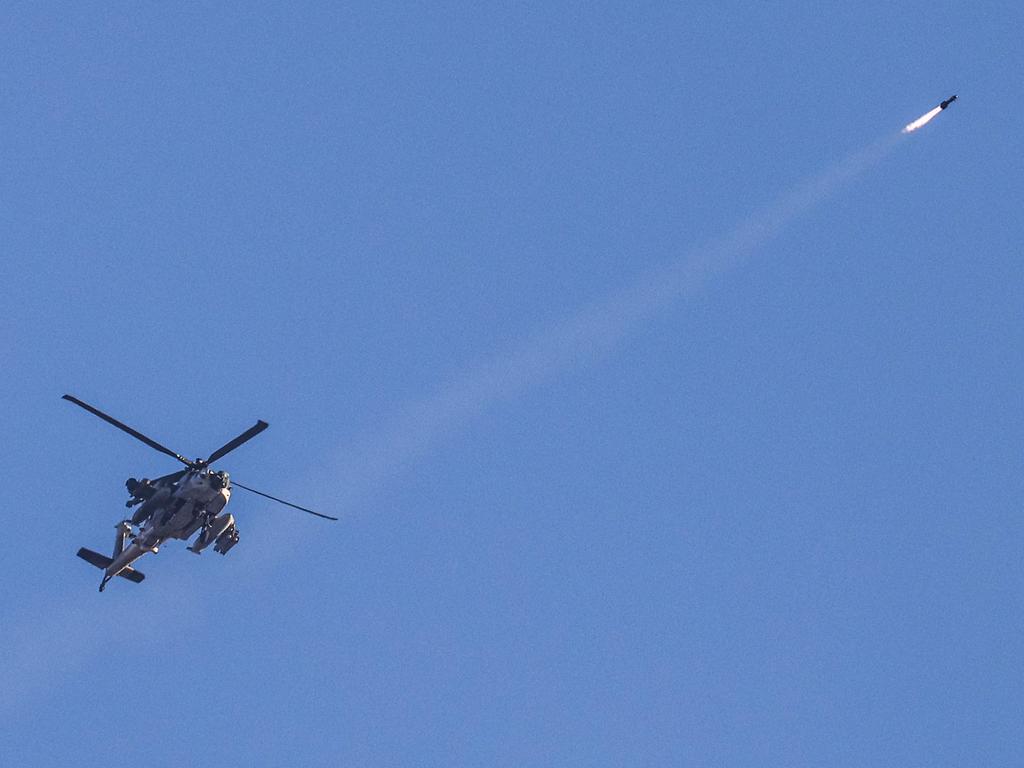 An Israeli air force attack helicopter fires a missile while flying over the border with the Gaza Strip near southern Israel. Picture: AFP