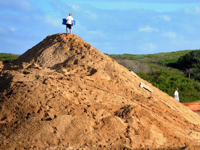 Children play on a sand pile near the entrance of Narrabeen Lagoon in 2011. Photo Manly Daily