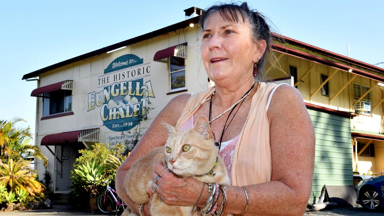 Eungella chalet manager Tess Ford with Charlie the cat, one year on from the Eungella fires. Picture: Tony Martin