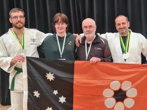 Darwin Judo Club representatives Kyle Mainey (left), Alannah Joyce (second from left) and Elefterios Spyropoulos (right) at the 2024 National Championships. Picture: Judo NT.