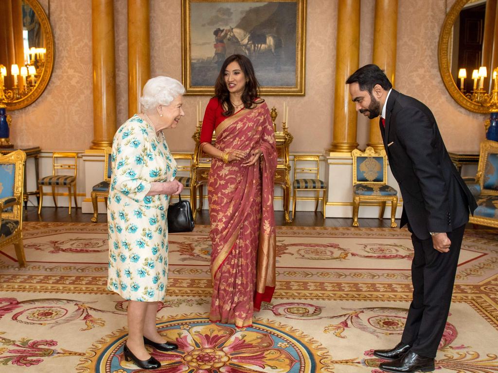 Britain's Queen Elizabeth II met with the High Commissioner of Sri Lanka Saroja Sirisena (c) and her husband Sudath Talpahewa but did not shake hands. Picture: Dominic Lipinski / POOL / AFP.