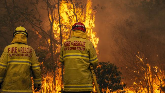 Firefighters work desperately to save homes as a large fire approached Bawley Point. Picture: Gary Ramage