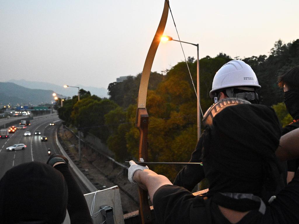 A protester points an arrow at cars on the Tolo Highway outside the Chinese University of Hong Kong (CUHK). Picture: Philip FONG / AFP.