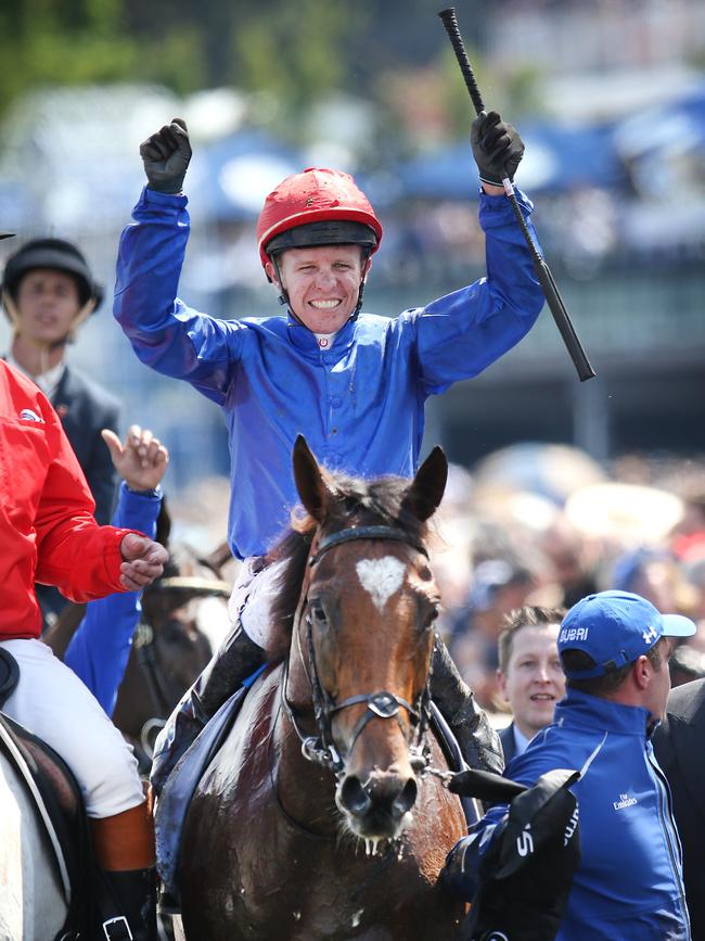 Jockey Kerrin McEvoy salutes to the crowd after his win. Picture: David Caird