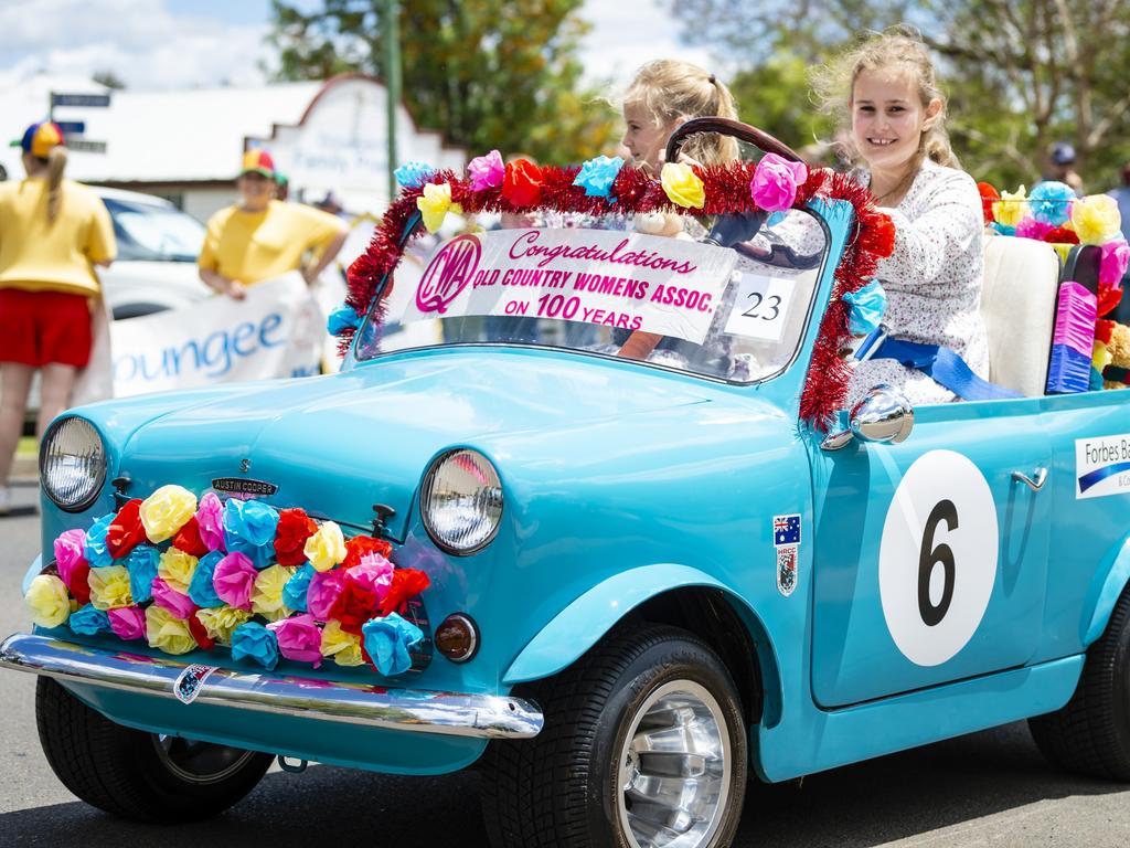 Driving in the Jacaranda Day grand parade in Goombungee is 10-year-old Chloe Brazier (behind the steering wheel) with her six-year-old sister Sophie, Saturday, November 5, 2022. Picture: Kevin Farmer