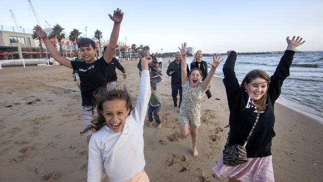 The Diaz and Garcia families celebrate New Year’s Eve at St Kilda beach. Picture: David Geraghty