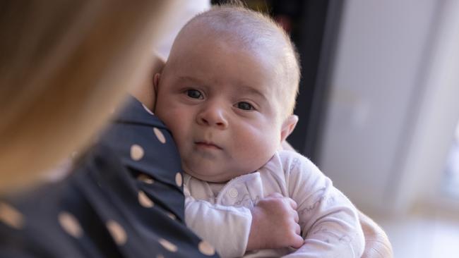 Max in mum’s arms. Picture: Mark Cranitch