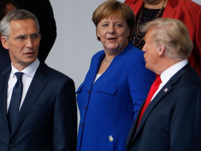 (LtoR) NATO Secretary General Jens Stoltenberg, German Chancellor Angela Merkel and US President Donald Trump talk during a family photo ahead of the opening ceremony of the NATO (North Atlantic Treaty Organization) summit, at the NATO headquarters in Brussels, on July 11, 2018.   / AFP PHOTO / GEOFFROY VAN DER HASSELT