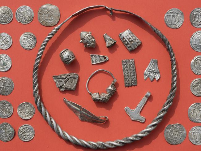 In this April 13, 2018 photo medieval jewelry and coins are displayed on a table after a medieval silver treasure had been found near Schaprode on the northern German island of Ruegen in the Baltic Sea.  (Stefan Sauer/dpa via AP)