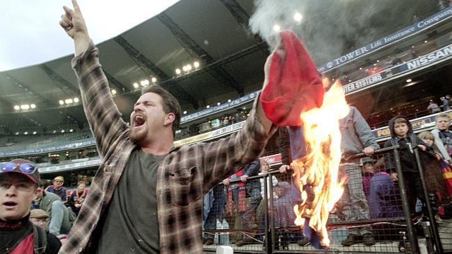 An emotional Fitzroy fan burns a Lions jumper after the club’s last match on Victorian soil.