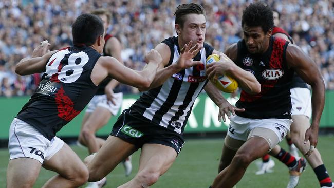 Darcy Moore tries to burst through two tacklers. Picture: Michael Klein