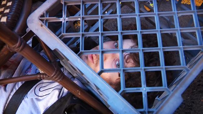 Mert Nay pinned under a milk crate. Picture: Seven News