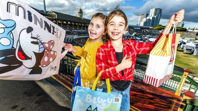 Seven-year-old Peggy Mackenzie and eight-year-old Esther McKeering at Brisbane Showgrounds with showbags for EKKA 2021. Picture: Richard Walker