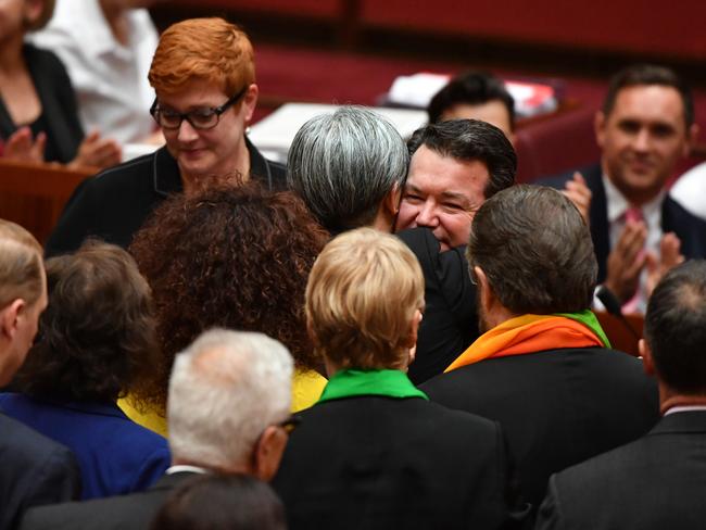 Shadow Minister for Foreign Affairs Penny Wong hugs Liberal Senator Dean Smith after the vote for the same-sex marriage bill passes. Picture: Mick Tsikas/AAP