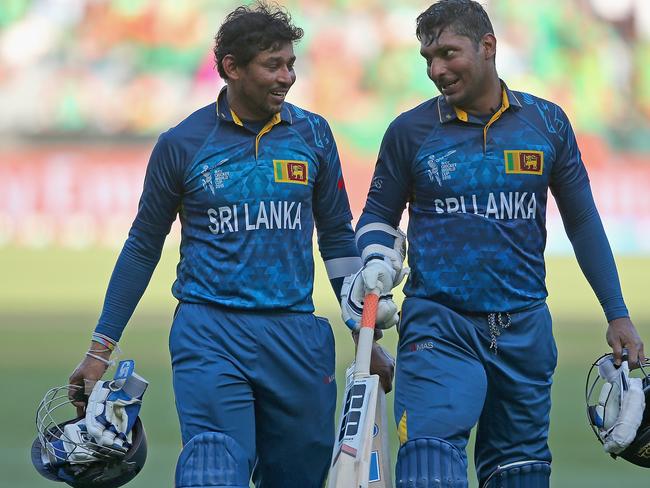 Tillakaratne Dilshan and Kumar Sangakkara of Sri Lanka walk off the field during the 2015 ICC Cricket World Cup in Melbourne.