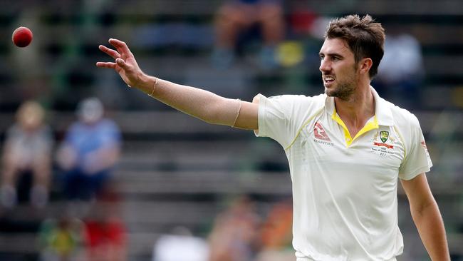 Pat Cummins reaches for the ball on the second day of the fourth Test.