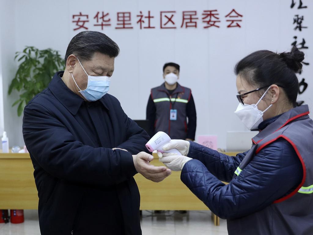 Chinese President Xi Jinping, wearing a protective face mask, receives a temperature check as he visits a community health centre in Beijing. Picture: Pang Xinglei/Xinhua via AP