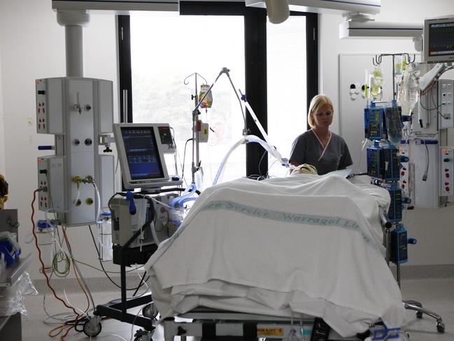 A fire burns victim is treated by ICU nurse Anna Dykes at The Alfred Hospital Burns Unit.