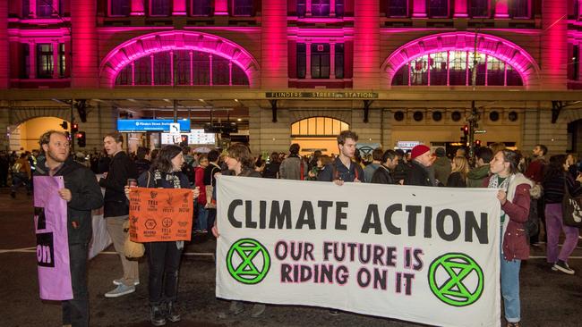 Extinction Rebellion protesters at the intersection of Flinders and Elizabeth Streets. Picture: Jake Nowakowski