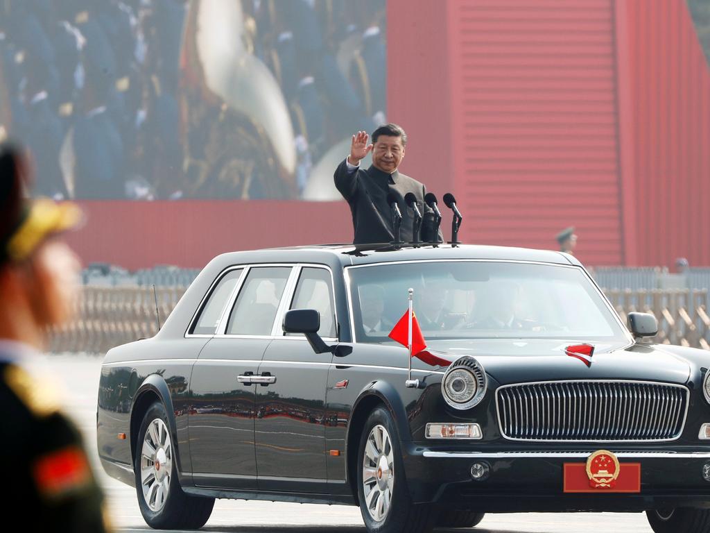 Chinese President Xi Jinping waves from a vehicle as he reviews the troops at a military parade marking the 70th founding anniversary of the People's Republic of China. Picture: Thomas Peter/Reuters