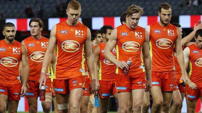 Gold Coast Suns players walk off after the loss. Picture: George Salpigtidis