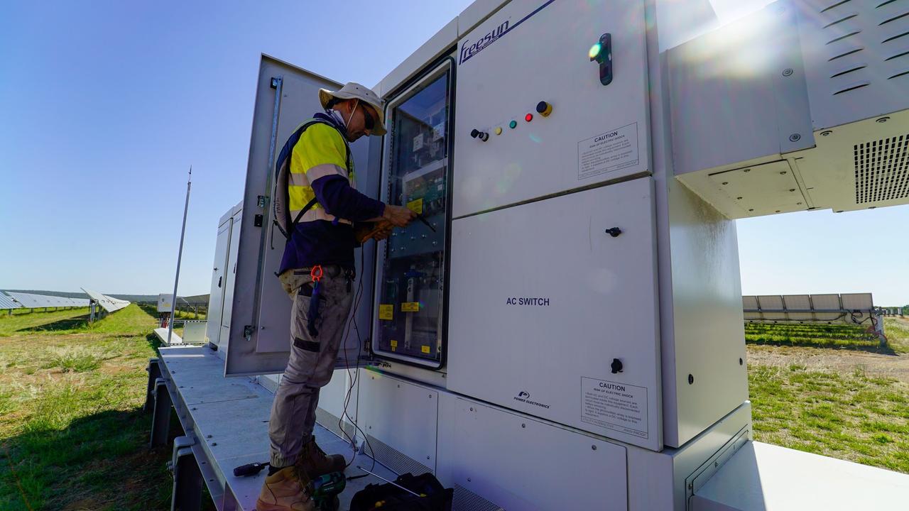 An electrician works on an inverter at Adani Renewables Australia's Rugby Run Solar Farm near Moranbah.