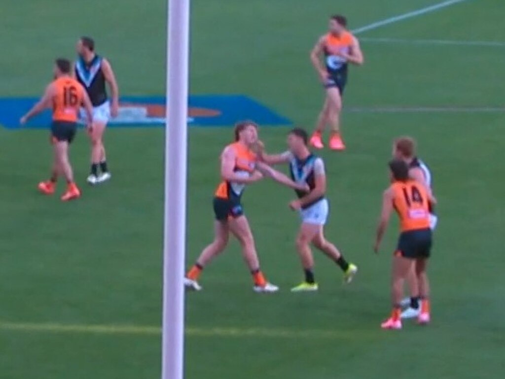 Zak Butters hits Giant Tom Green off the ball. Picture: Fox Footy