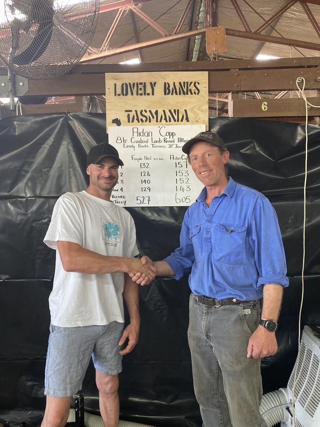 Aidan Copp is congratulated by Lovely Banks owner Tim McShane after his record-breaking lamb shearing feat in Tasmania.