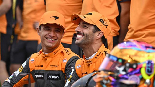 McLaren's British driver Lando Norris (L) and McLaren's Australian driver Daniel Ricciardo (R) pose for a group picture with their team ahead of the Abu Dhabi Formula One Grand Prix at the Yas Marina Circuit in the Emirati city of Abu Dhabi on November 20, 2022. (Photo by Ben Stansall / AFP)