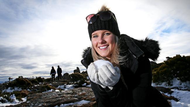 Hobart resident Jess Fenner got to grips with light snow at the summit of Mt Wellington today. Picture: Sam Rosewarne