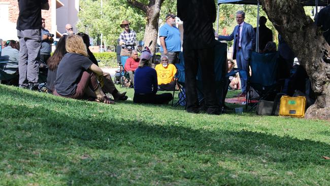 Lawyer Gerard Mullins KC speaks with members of Kumanjayi Walker’s family on the lawns outside court in May. Picture: Jason Walls