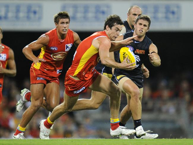 Suns player Marc Lock runs with the ball during the 2nd round AFL match between the Gold Coast Suns and Carlton at the Gabba in Brisbane, Saturday, April 2, 2011. (AAP Image/Dave Hunt) NO ARCHIVING