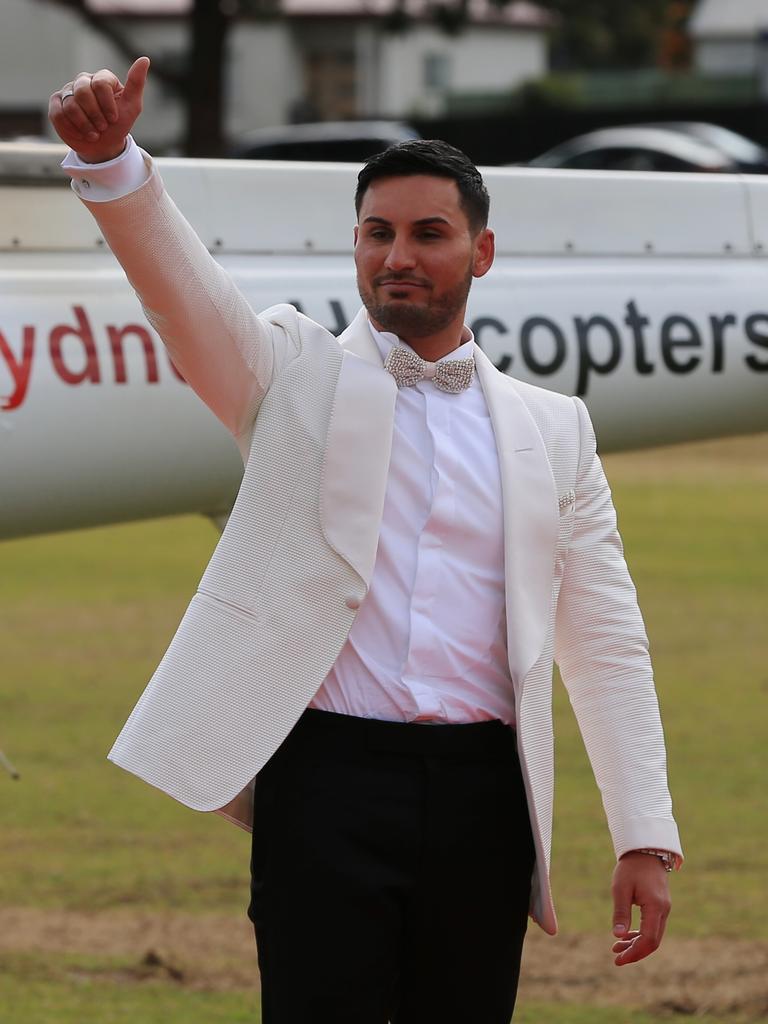 Auburn deputy mayor Salim Mehajer waves to the crowd of people gathered at the park in Lidcombe ahead of his wedding. Picture: Toby Zerna