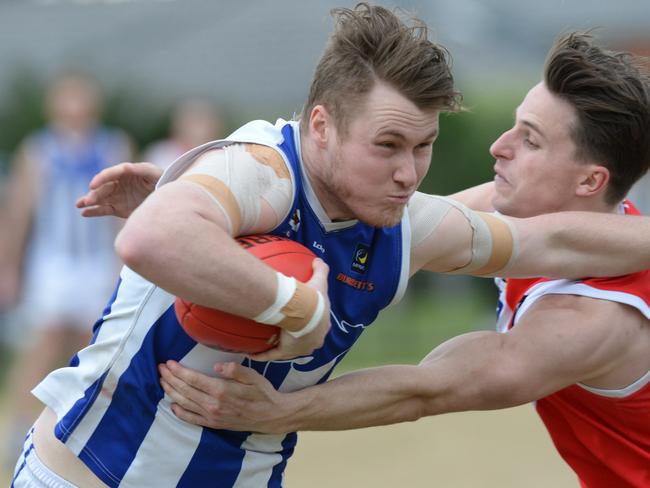 MPNFL Division 2 second semi-final: Red Hill v Langwarrin at Chelsea. Langwarrin #8 Jesse Murrphy tackled by Red Hill #61 James Fletcher.  Picture: AAP/ Chris Eastman