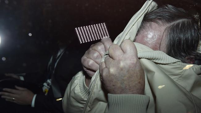 Gregory Keith Davies is escorted from City West Police Station. Picture: Ellen Smith