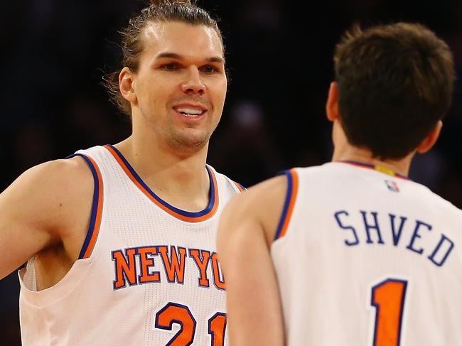 NEW YORK, NY - MARCH 17: Lou Amundson #21 of the New York Knicks celebrates his game tying basket with Alexey Shved #1 forcing the game into overtime against the San Antonio Spurs during their game at Madison Square Garden on March 17, 2015 in New York City. NOTE TO USER: User expressly acknowledges and agrees that, by downloading and/or using this photograph, user is consenting to the terms and conditions of the Getty Images License Agreement. Al Bello/Getty Images/AFP == FOR NEWSPAPERS, INTERNET, TELCOS & TELEVISION USE ONLY ==