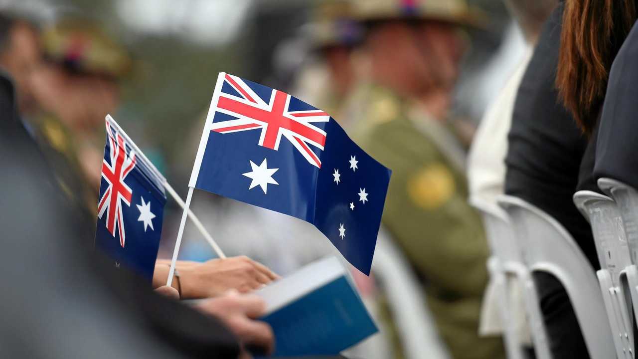 Memmbers of the public hold flags at an Australia Day Citizenship Ceremony and Flag Raising event in Canberra on Tuesday, Jan. 26, 2016. (AAP Image/Mick Tsikas) NO ARCHIVING. Picture: MICK TSIKAS