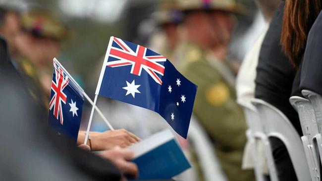 Memmbers of the public hold flags at an Australia Day Citizenship Ceremony and Flag Raising event in Canberra on Tuesday, Jan. 26, 2016. (AAP Image/Mick Tsikas) NO ARCHIVING. Picture: MICK TSIKAS