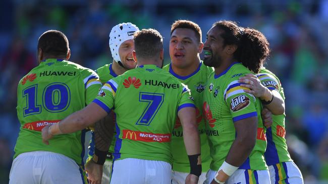 Iosia Soliola celebrates with Canberra teammates after scoring a try.