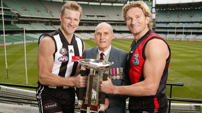 Former captains Nathan Buckley and James Hird with World War II veteran Harold Lambert at the MCG ahead of an Anzac Day clash.