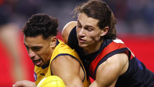 AFL Round 17. Essendon vs Adelaide at Marvel Stadium, Melbourne. 09/07/2021.  Archie Perkins of the Bombers tackled Ben Davis of the Crows during the 2nd qtr.     .  Pic: Michael Klein