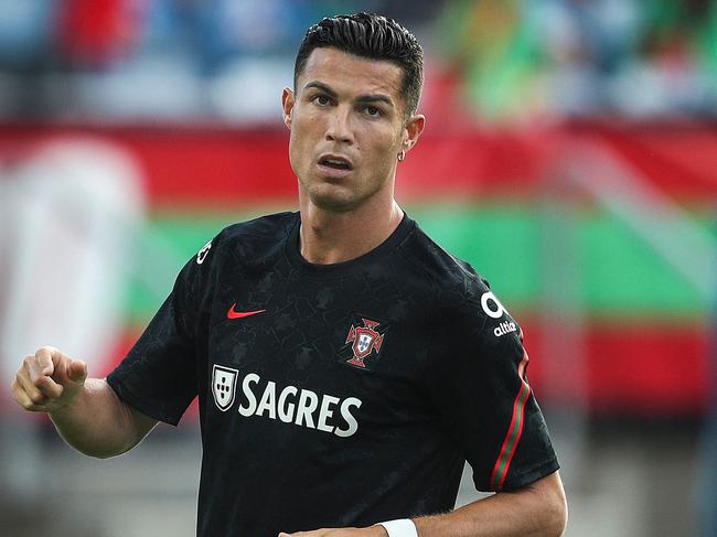 Portugal's forward Cristiano Ronaldo warms up before the FIFA World Cup Qatar 2022 European qualifying round group A football match between Portugal and Republic of Ireland at the Algarve stadium in Loule, near Faro, southern Portugal, on September 1, 2021. (Photo by CARLOS COSTA / AFP)