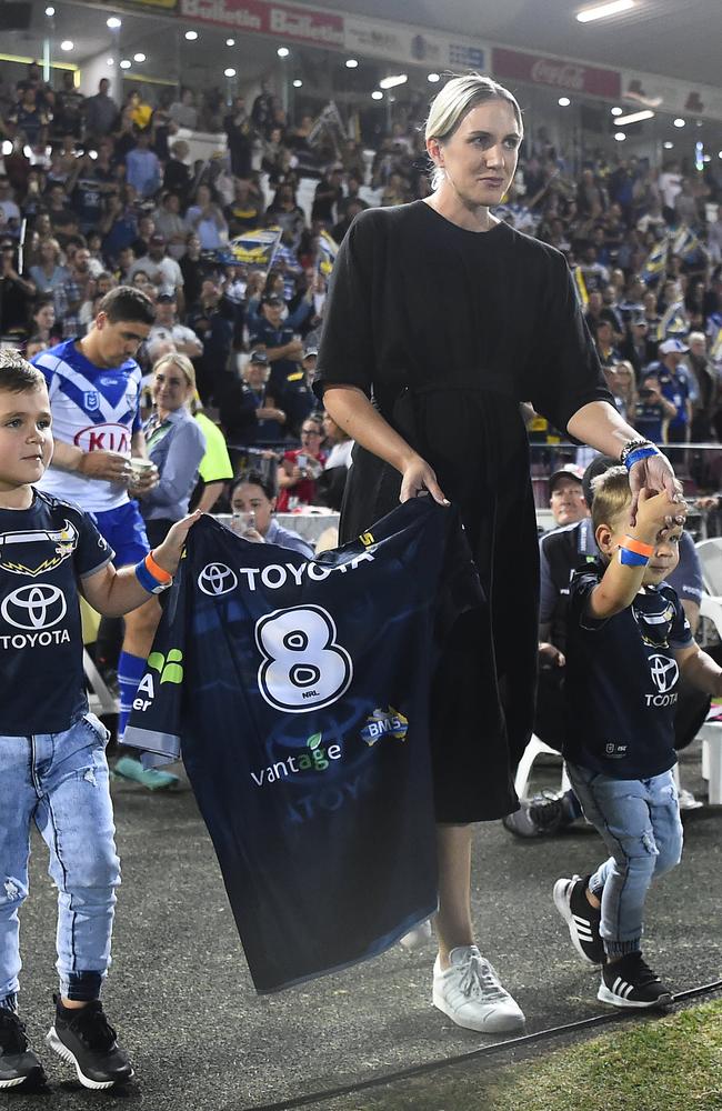 Matt Scott's wife Lauren and his two sons Hugo and Wil walk onto the field holding his jersey on August 29, 2019 in Townsville. Picture: Ian Hitchcock/Getty Images,