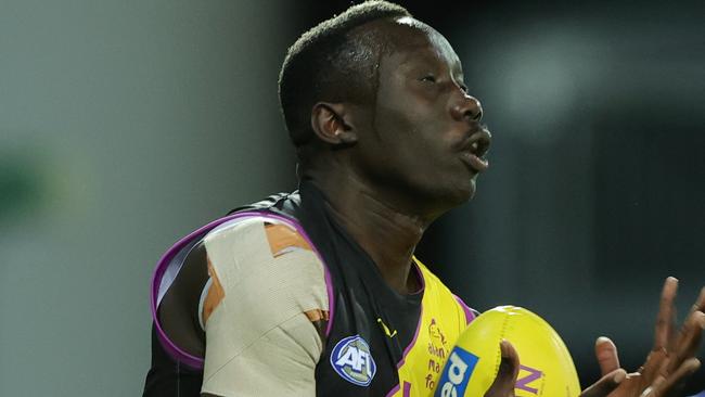 GOLD COAST, AUSTRALIA – JULY 16: Mabior Chol marks the ball during the 2021 AFL Round 18 match between the Richmond Tigers and the Brisbane Lions at Metricon Stadium on July 16, 2021 in the Gold Coast, Australia. (Photo by Russell Freeman/AFL Photos via Getty Images)