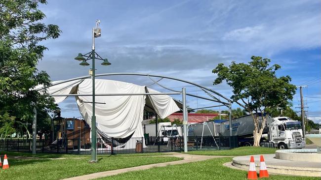 The shade sail covering the Hinchinbrook Shire Council playground in Rotary Park has been destroyed with trucks in the background waiting for the Bruce Highway north of Ingham to reopen. Picture: Cameron Bates