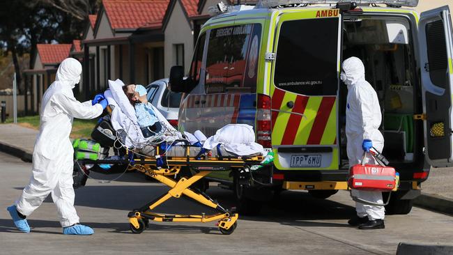 Paramedics take a resident of St Basil’s Home for the Aged in Melbourne’s north to hospital on Friday. Picture: Aaron Francis