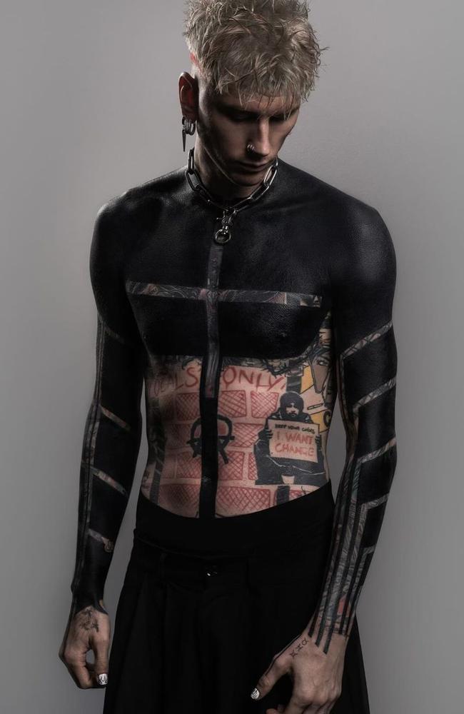 A man shows off his bodysuit during the International tattoo