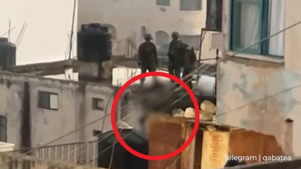 Shock footage of Israeli soldiers allegedly kicking dead Palestinian off a roof. Picture: AlJazeera