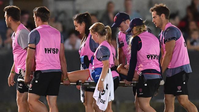 Meg Downie is stretchered from the field after being knocked out by Magpie Sophie Casey. Picture: Getty