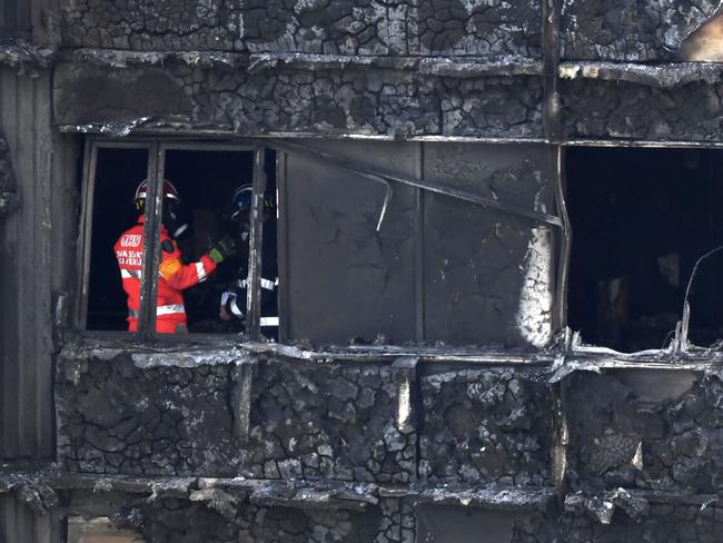 Emergency workers and police inspect inside the remains of Grenfell Tower. Picture: AFP